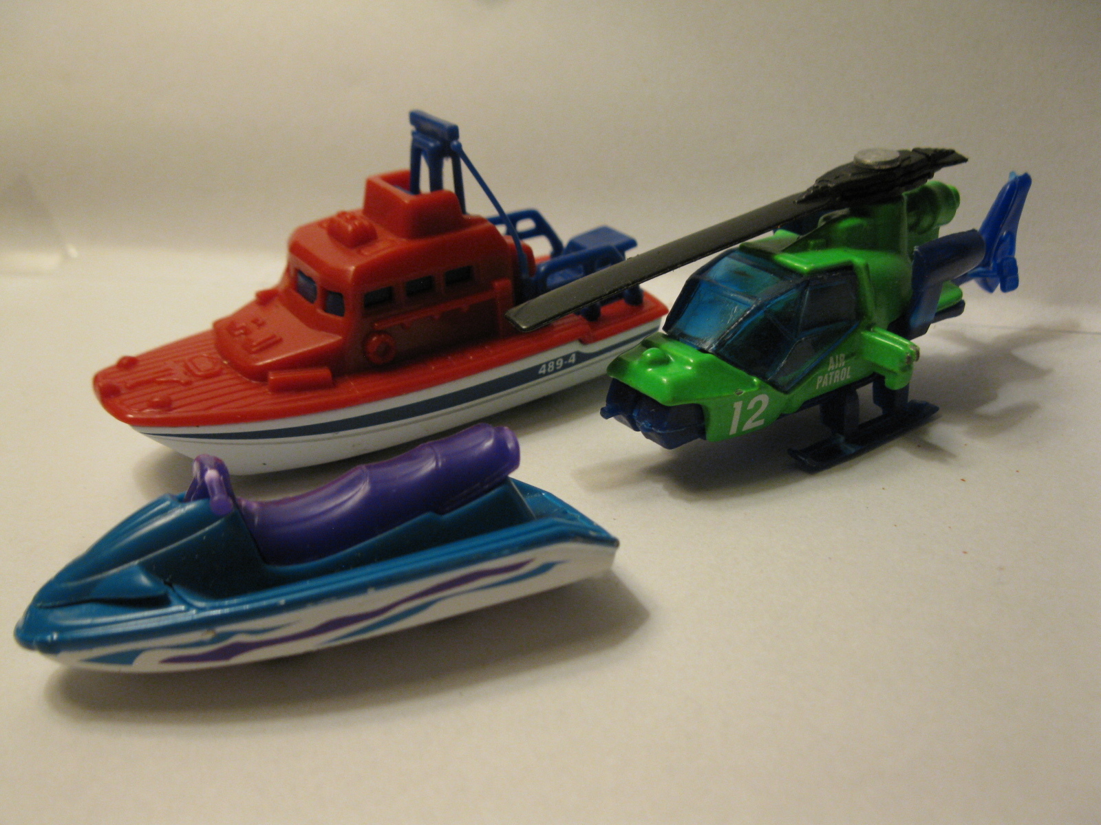 Primary image for lot of 3 diecast vehicles: '98 Sea Rescue boat, '98 Watercraft & '85 Helicopter