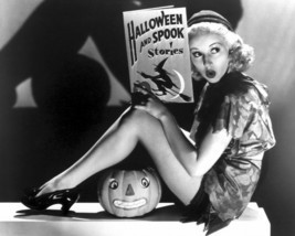 Betty Grable 8x10 Photo sexy leggy pose holding Halloween book - £6.38 GBP