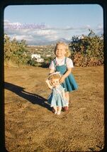 35 mm color slide * 1959 LITTLE GIRL with her DOLL on Hillside view behi... - $5.45