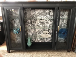 Beautiful display case with two doors; glass shelves and a botanical bac... - $500.00