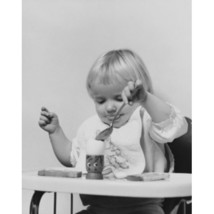 Posterazzi Baby Sitting in a High Chair &amp; Eating an Egg Poster Print - 1... - $1,167.19 MXN