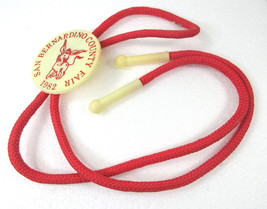 1982 San Bernardino County Fair Bolo Tie Donkey Arrow Plastics Round Souvenir - £11.83 GBP