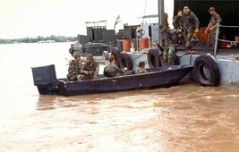 US Navy SEAL members board a boat on the Mekong River during Vietnam Photo Print - $8.81+