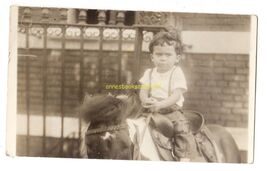 vintage snapshot from album  * young boy on pony not an happy face - $7.50
