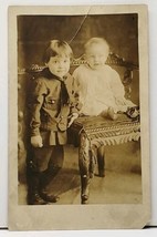 RPPC Child in Uniform with Baby on Chair Real Photo Postcard H14 - £5.46 GBP
