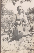 Farmer Sitting In FIELD-BIB OVERALLS-HOLDS Dog &amp; PIG~1910s Real Photo Postcard - £8.14 GBP