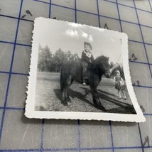 Vintage Photograph Little Boy In Cowboy Outfit On Pony 1950s Black And W... - $221.06 MXN