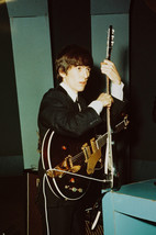 George Harrison in Black Suit and Tie Holding Two Guitars Beatles 24x18 Poster - $23.99