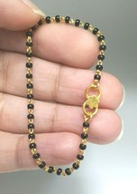 18ct Yellow gold Baby Bracelet Black-beads with Diamond cut design - $264.05