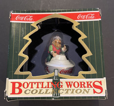COCA COLA BOTTLING WORKS COLLECTION CHRISTMAS ORNAMENT-Elf on Bottle Top - $224.20 MXN