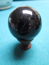 Black Glass studio paperweight on wood  base, 1 1/2&quot; diam - $55.43
