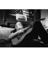 Willie Nelson lying on bed with guitar under American flag 12x18 Poster - $373.69 MXN