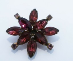 Lovely vintage purple rhinestone star flower shaped brooch set in gold tone - $19.99