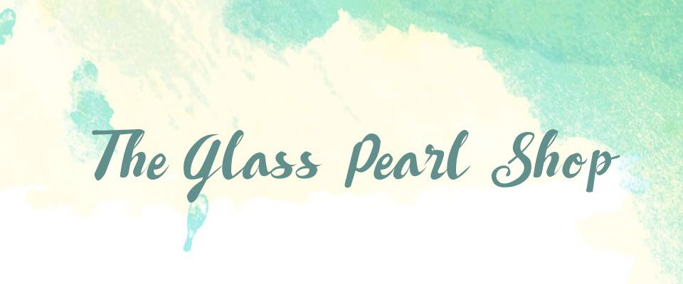 A welcome banner for The Glass Pearl Shop booth